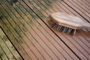 About People Helping People brush cleaning dirty wood deck