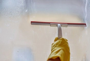 About People Helping People window squeegee cleaning glass