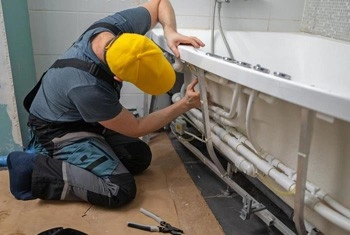 About People Helping People technician working on wall fixture