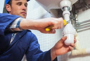 About People Helping People plumber repairing a bathroom sink trap
