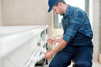 About People Helping People plumber repairing bathtub pipework