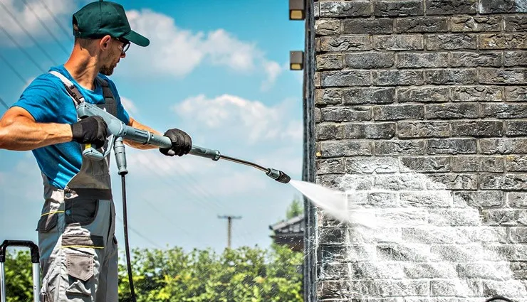About People Helping People pressure washing stained brick wall