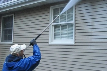 About People Helping People soft washing home siding near windows