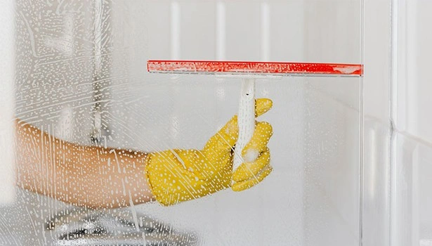 About People Helping People squeegee cleaning a soapy glass window