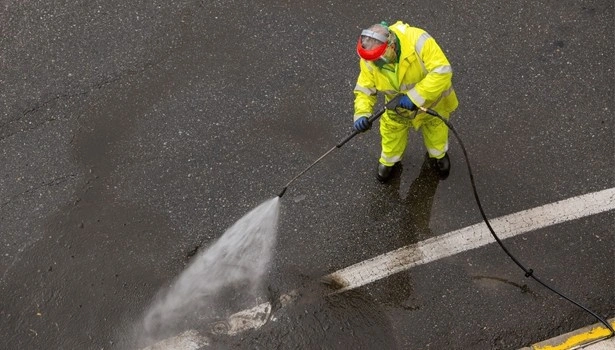 About People Helping People pressure washing stained pavement