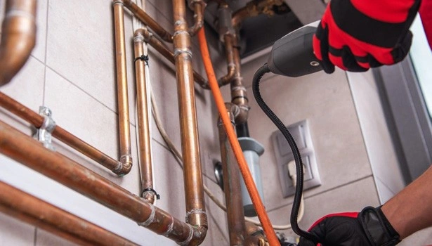 About People Helping People inspecting copper plumbing pipes