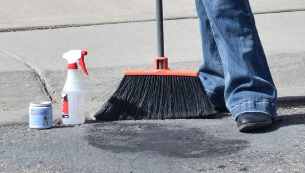 About People Helping People parking lot stain cleaning with broom