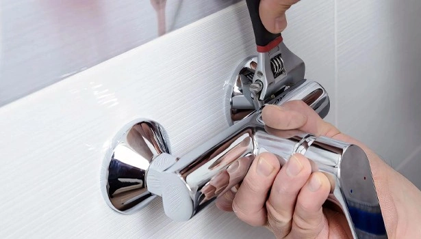 About People Helping People plumber tightening bathroom shower valve